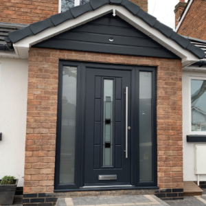 a photograph of a black rockdoor with frosted glass side panels